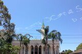 A message reading 'Merry Xmas' appears in the sky above Lakemba Mosque in Sydney.