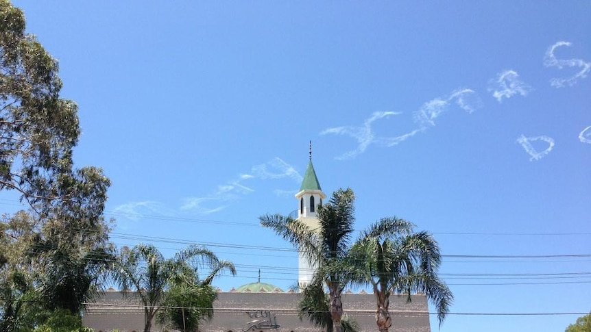 A message reading 'Merry Xmas' appears in the sky above Lakemba Mosque in Sydney.