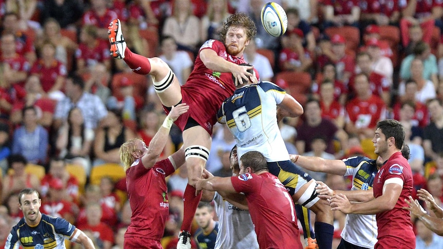Eddie Quirk of the Reds competes against the Brumbies