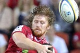 Eddie Quirk of the Reds competes against the Brumbies