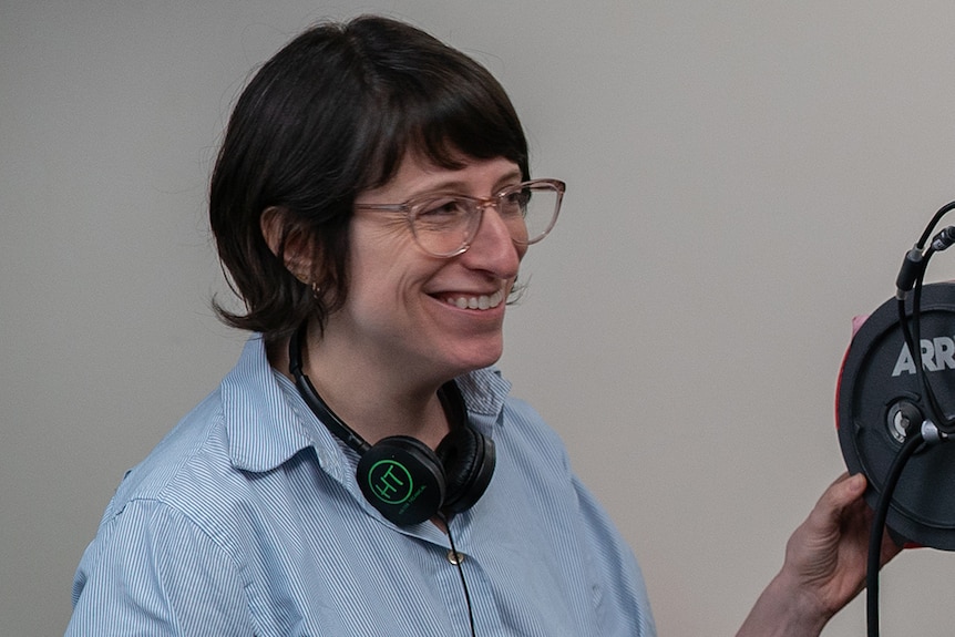 Writer and director of Never Rarely Sometimes Always, Eliza Hittman with headphones around neck, holding the back of a camera