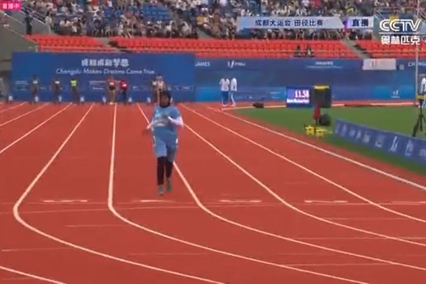 Somalia's Nasra Abukar crosses the line last in the women's 100 metres at the FISU World University Games in Chengdu, China.
