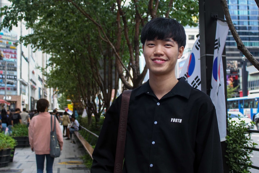 Young man standing in the street in Seoul