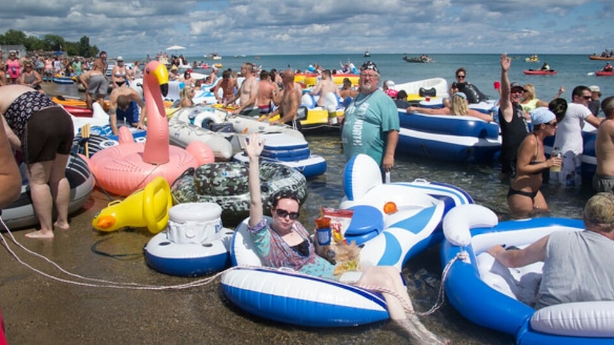 People in inflatable rafts and pool toys line up to take part in the Port Huron Float Down.