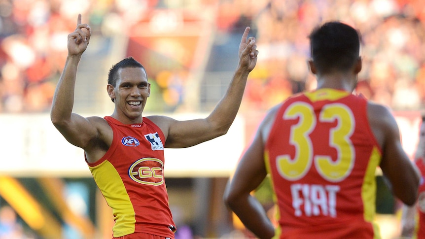 Suns player Harley Bennell (L) reacts to his goal against Western Bulldogs at Carrara in May 2014.
