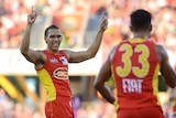 Suns player Harley Bennell (L) reacts to his goal against Western Bulldogs at Carrara in May 2014.