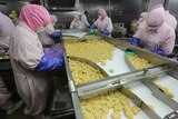Employees work at a production line at the Husi Food factory in Shanghai