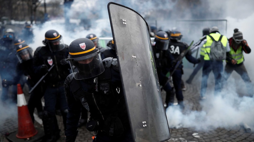 Protesters clash with riot police on the Champs-Elysee in Paris.