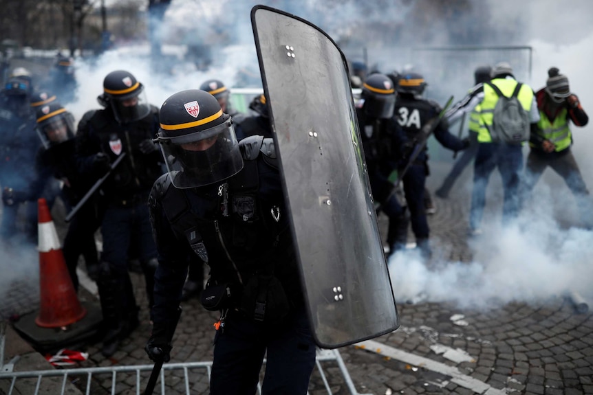 Protesters clash with riot police on the Champs-Elysee in Paris.