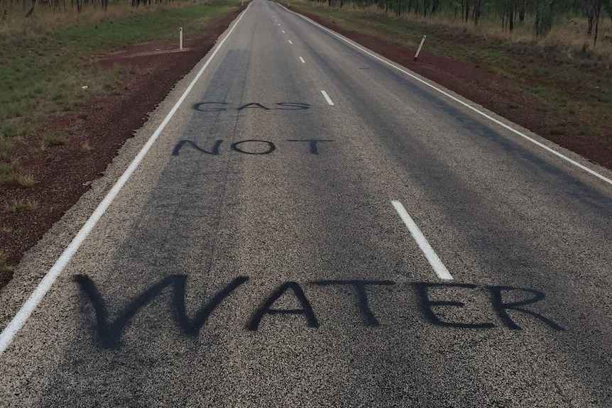 'Water not gas' painted on the Stuart Highway, south of Katherine