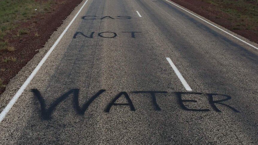 'Water not gas' painted on the Stuart Highway, south of Katherine