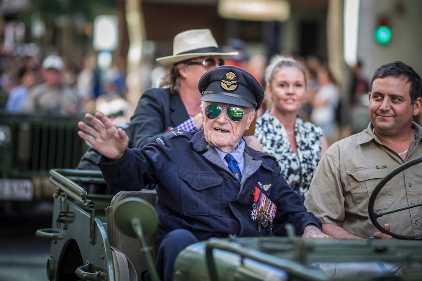 Veteran Bob Jackson waves from a jeep during an Anzac Day parade in Brisbane, Australia.