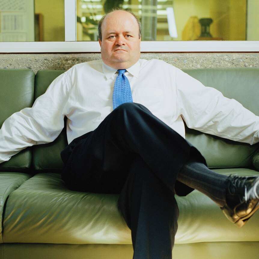 a large man sitting on a couch