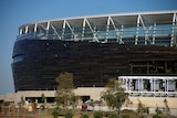 A close up shot of the Perth stadium, which has wood panelling and all-glass sections.