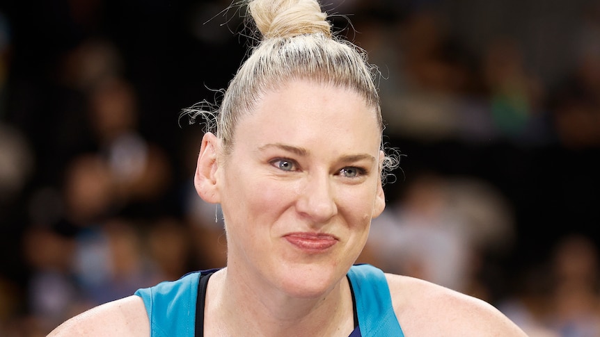 Lauren Jackson smiles wearing a blue singlet