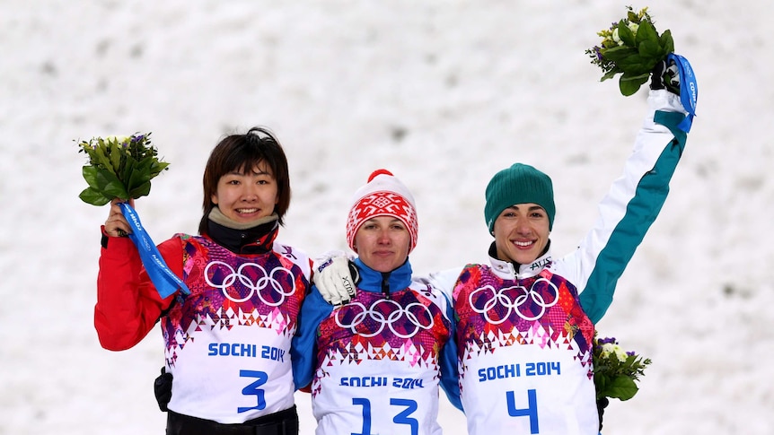 Lassila celebrates with fellow medallists