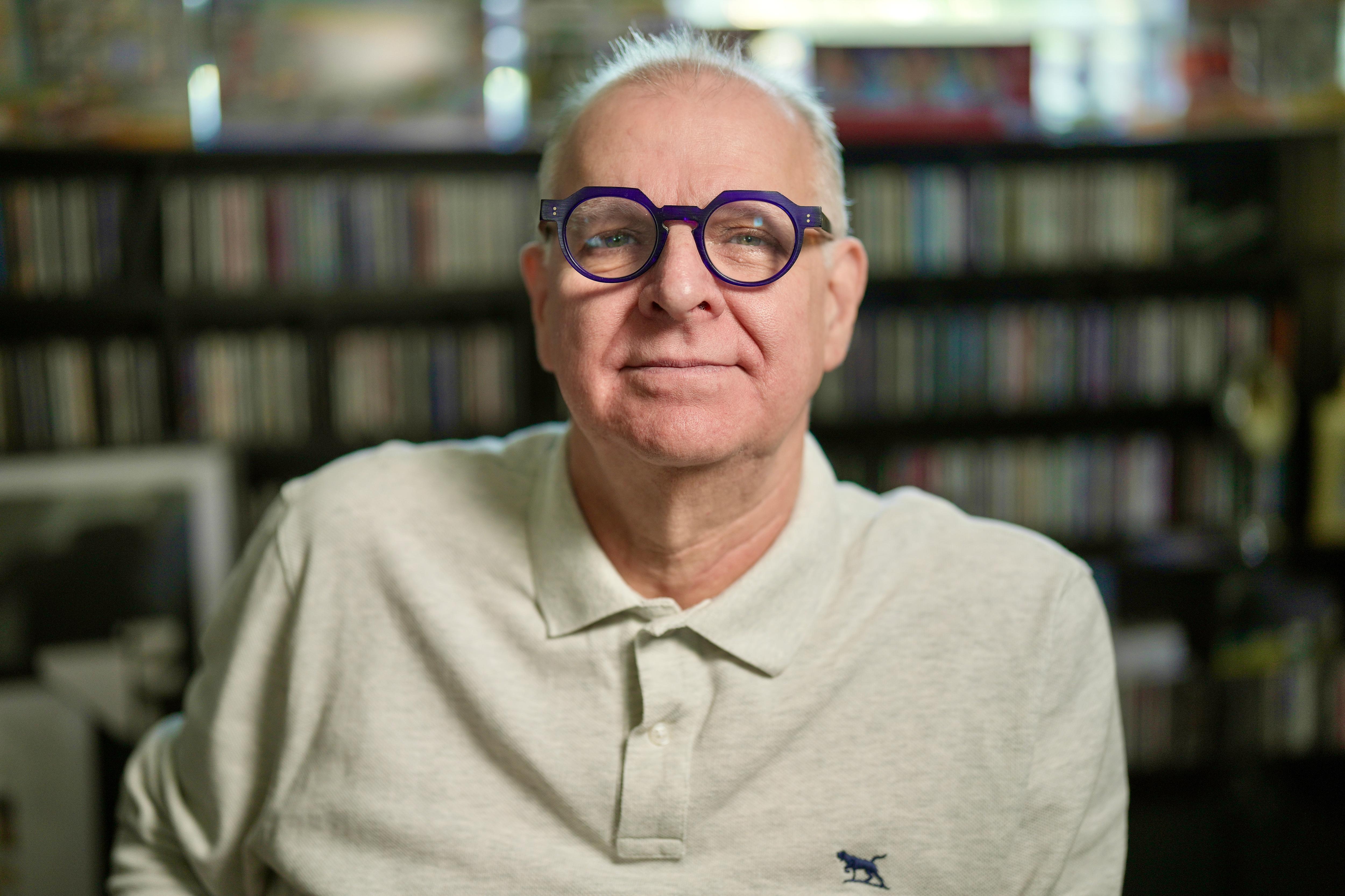 A middle aged white man with short grey hair sitting in an office