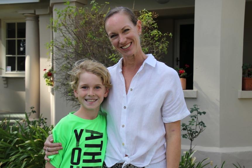 Cooper and Jayne Smeulders stand outside their home.