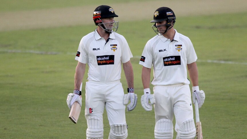 Western Australian batsmen Shaun Marsh and Hilton Cartwright leave the field.