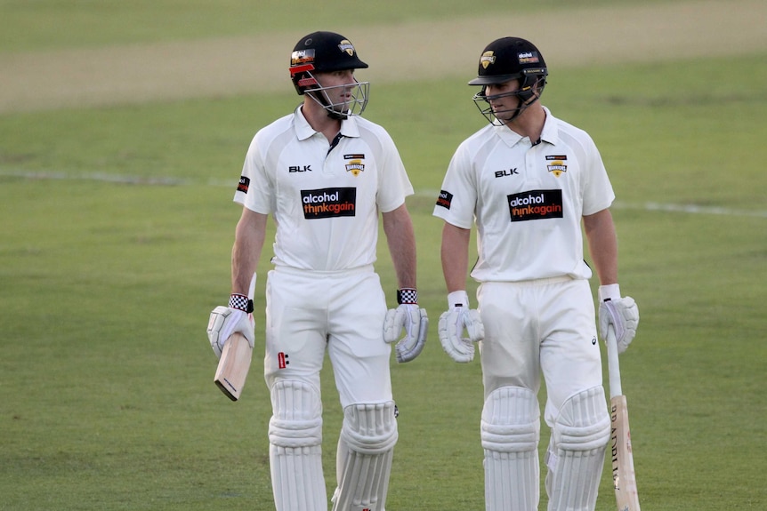 Western Australian batsmen Shaun Marsh and Hilton Cartwright leave the field.