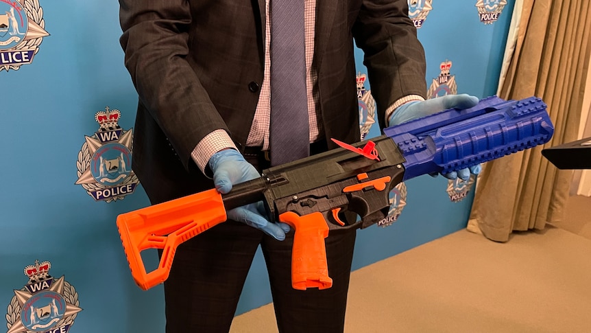 A DIY 3D Printed firearm seized by police being displayed at a press conference