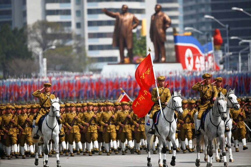 North Korean soldiers march during the military parade marking the105th birth anniversary of country's founding father Kim Il Sung.