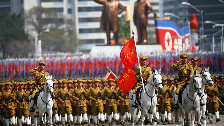 North Korean soldiers march during the military parade marking the105th birth anniversary of country's founding father Kim Il Sung.