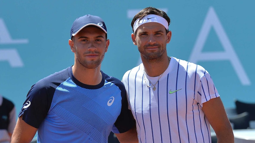 Grigor Dimitrov (right) and Borna Coric embrace at the net before a match on the Adria Tour.