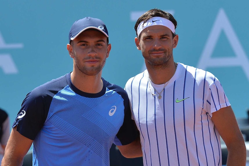 Grigor Dimitrov (right) and Borna Coric embrace at the net before a match on the Adria Tour.