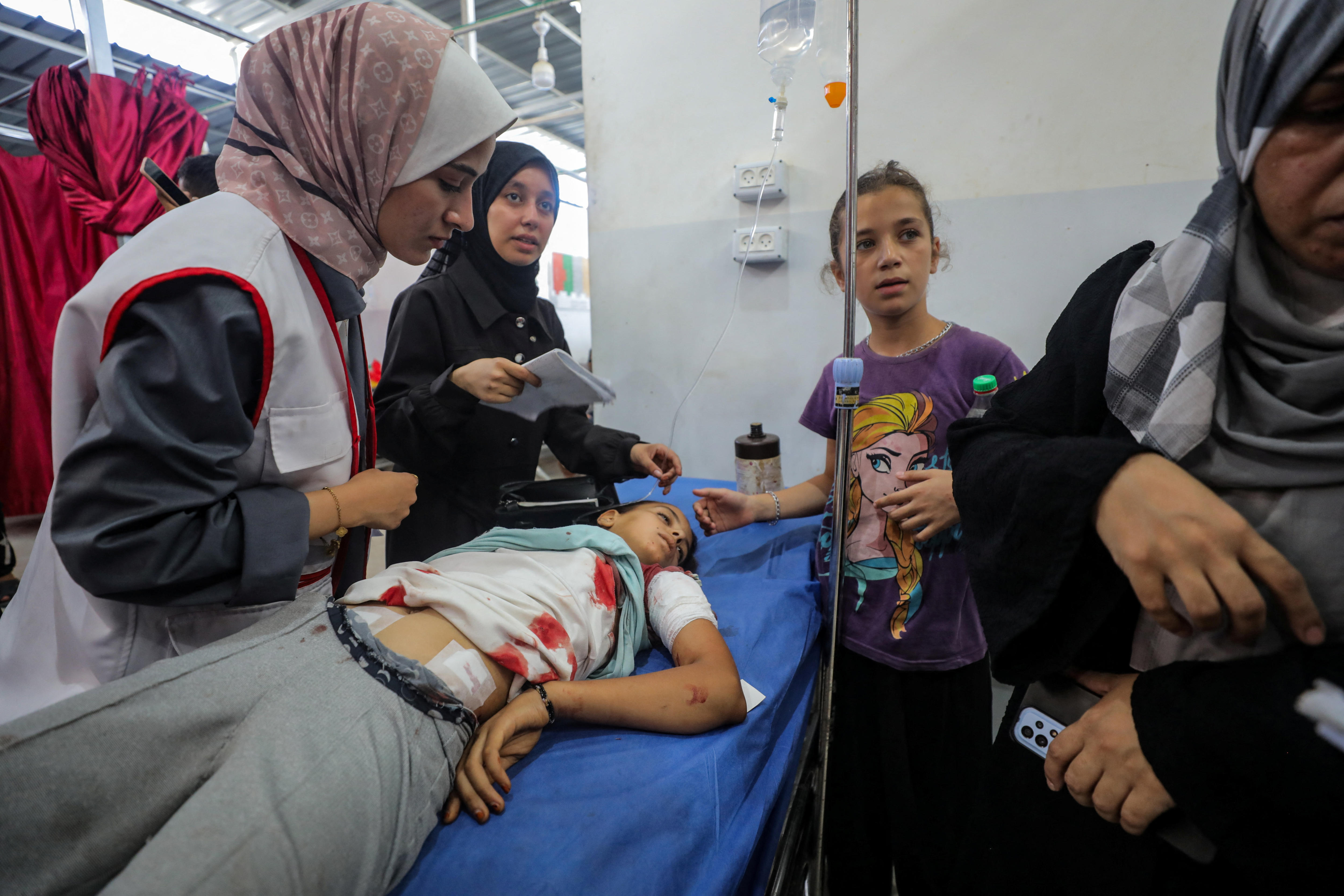 A wounded Palestinian girl receives treatment from medics in hospital