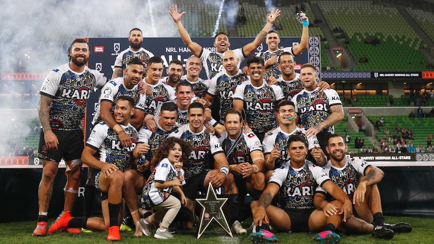 A group of Indigenous rugby league players pose for a group shot after winning the All Stars game.