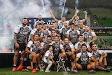 A group of Indigenous rugby league players pose for a group shot after winning the All Stars game.