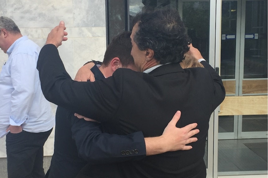 Harlan Agresti hugs his family.