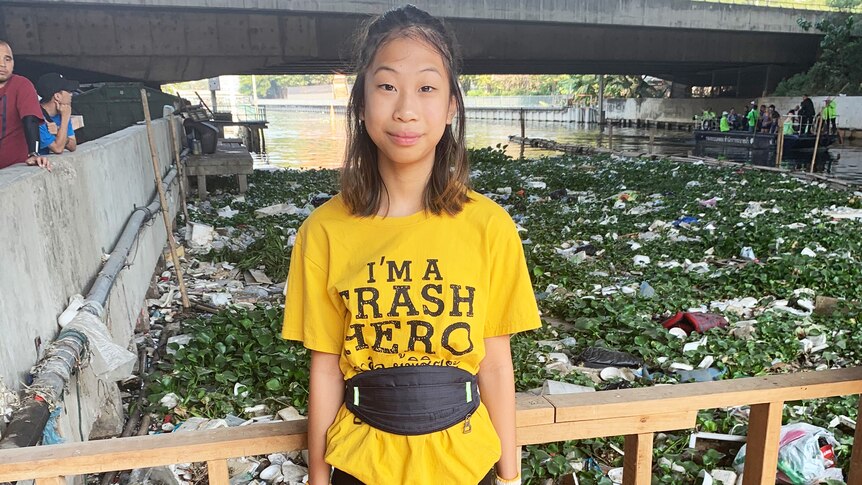 Lilly stands in front of a canal full of rubbish in Bangkok, Thailand, December 20, 2019.