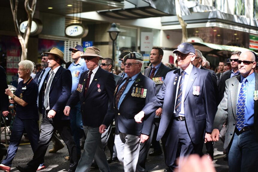 Veterans march in the Anzac Day Parade through Brisbane's CBD