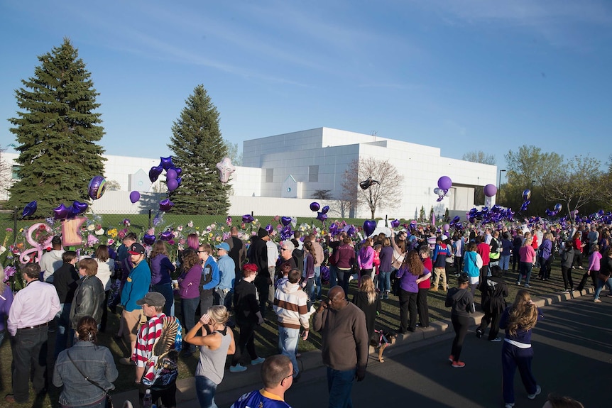 Music fans visit a memorial outside Paisley Park.