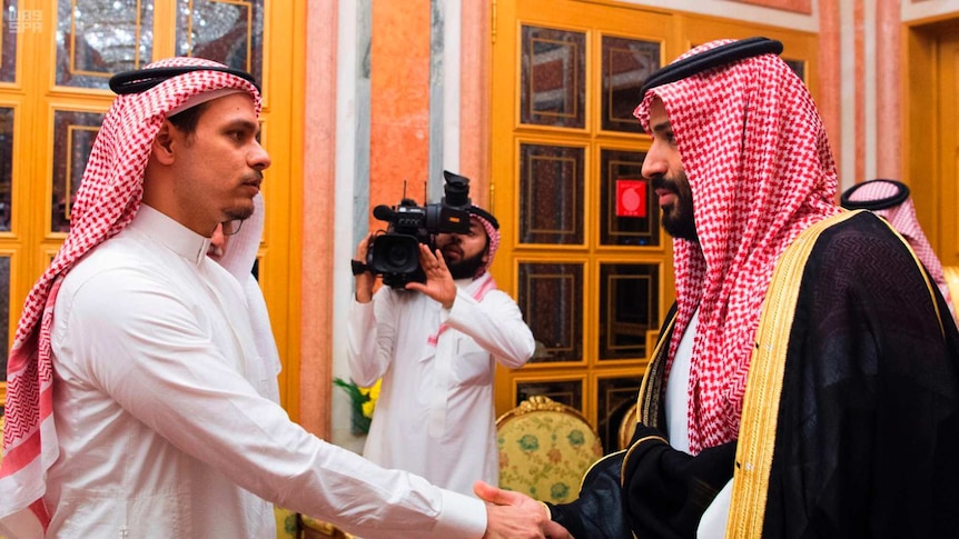 Saudi Crown Prince Mohammed bin Salman, right, shakes hands with Salah Khashoggi, a son, of Jamal Khashoggi
