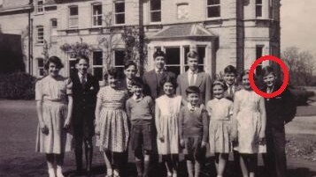 A black-and-white photo of a group of children from the 1950s and 60s