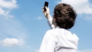 A man attempts to find mobile reception