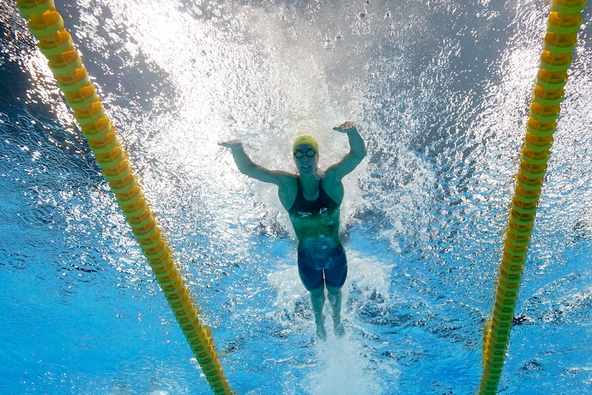 An Australian female swimmer competes in the 100 metres butterfly at the Tokyo Olympics.