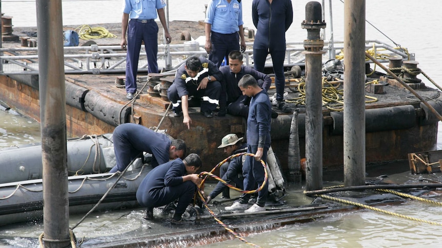 Indian Navy divers and personnel are pictured at the conning tower of the stricken INS Sindhurakshak
