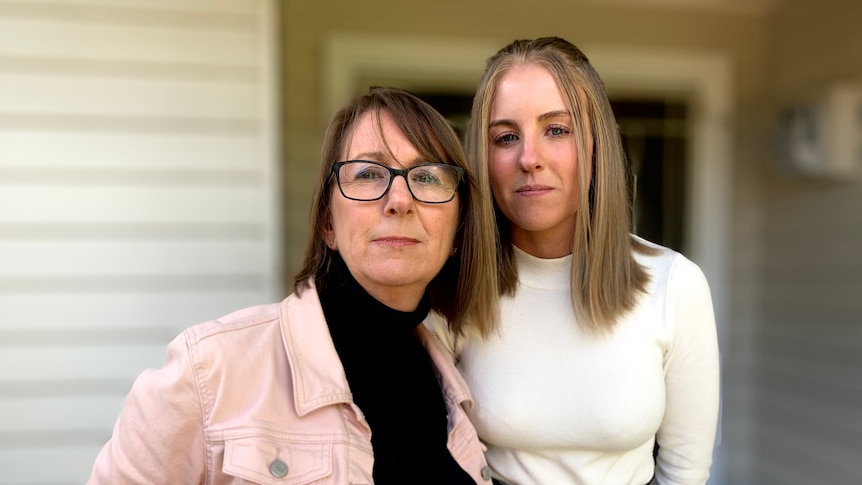 Prue Mc-Lardie Hore (right in white top) with mother Fiona (left) outside their home.