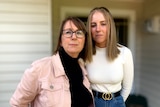 Prue Mc-Lardie Hore (right in white top) with mother Fiona (left) outside their home.