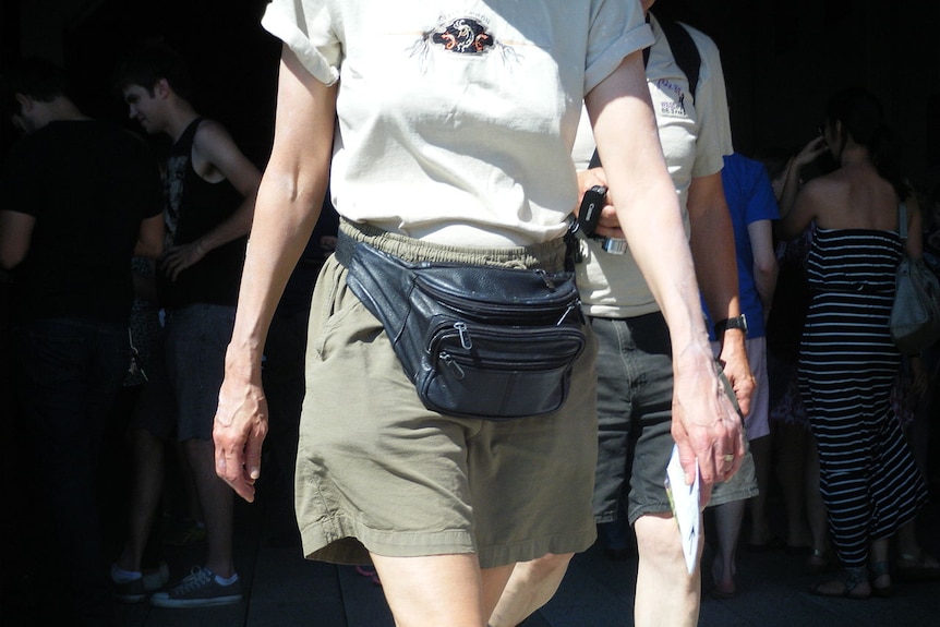 Woman wearing a black leather bum bag