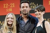 Amanda Seyfreid, Hugh Jackman and Anne Hathaway pose at promotional event for Les Miserables.
