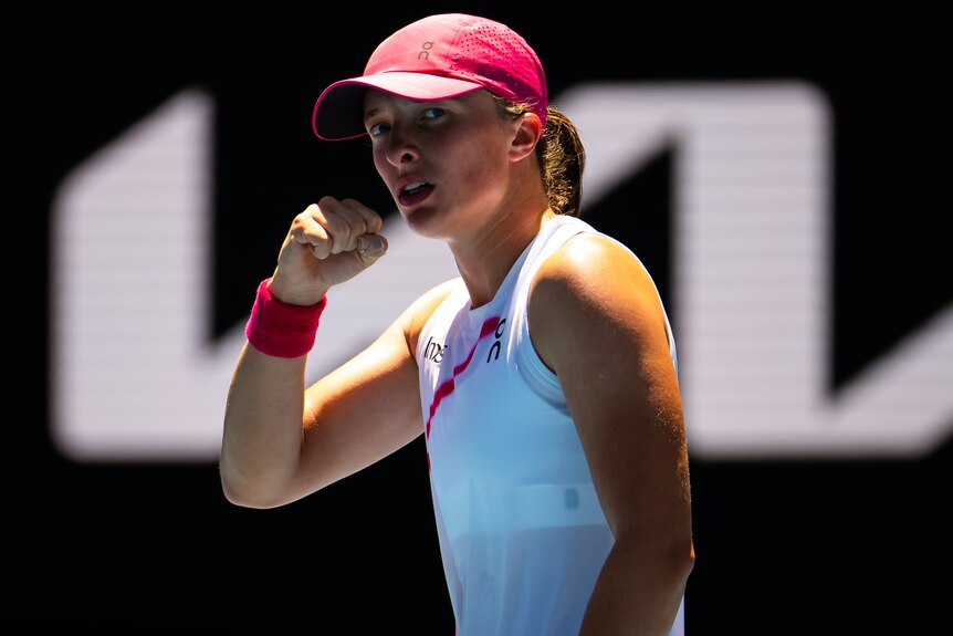 Iga Świątek pumps her fist during a match at the 2024 Australian Open.