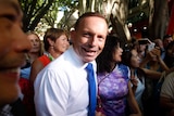 Prime Minister Tony Abbott smiles as he walks through a crowded Chinatown in Sydney.