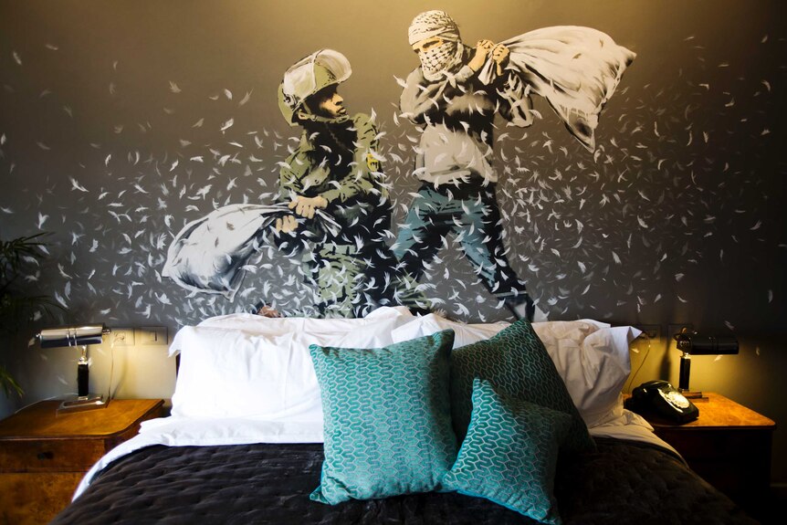 A Banksy wall painting showing Israeli border policeman and Palestinian in a pillow fight