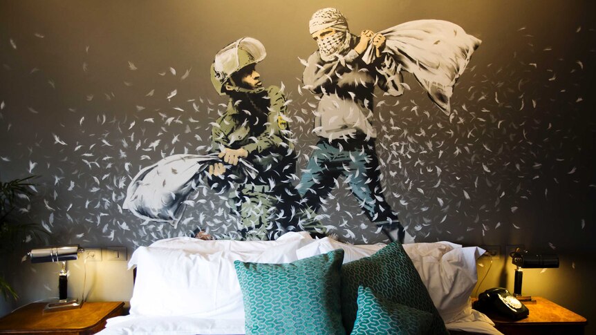 A Banksy wall painting showing Israeli border policeman and Palestinian in a pillow fight