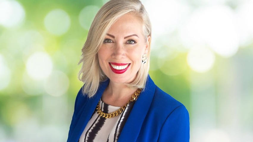 a woman in a blue jacket smiling